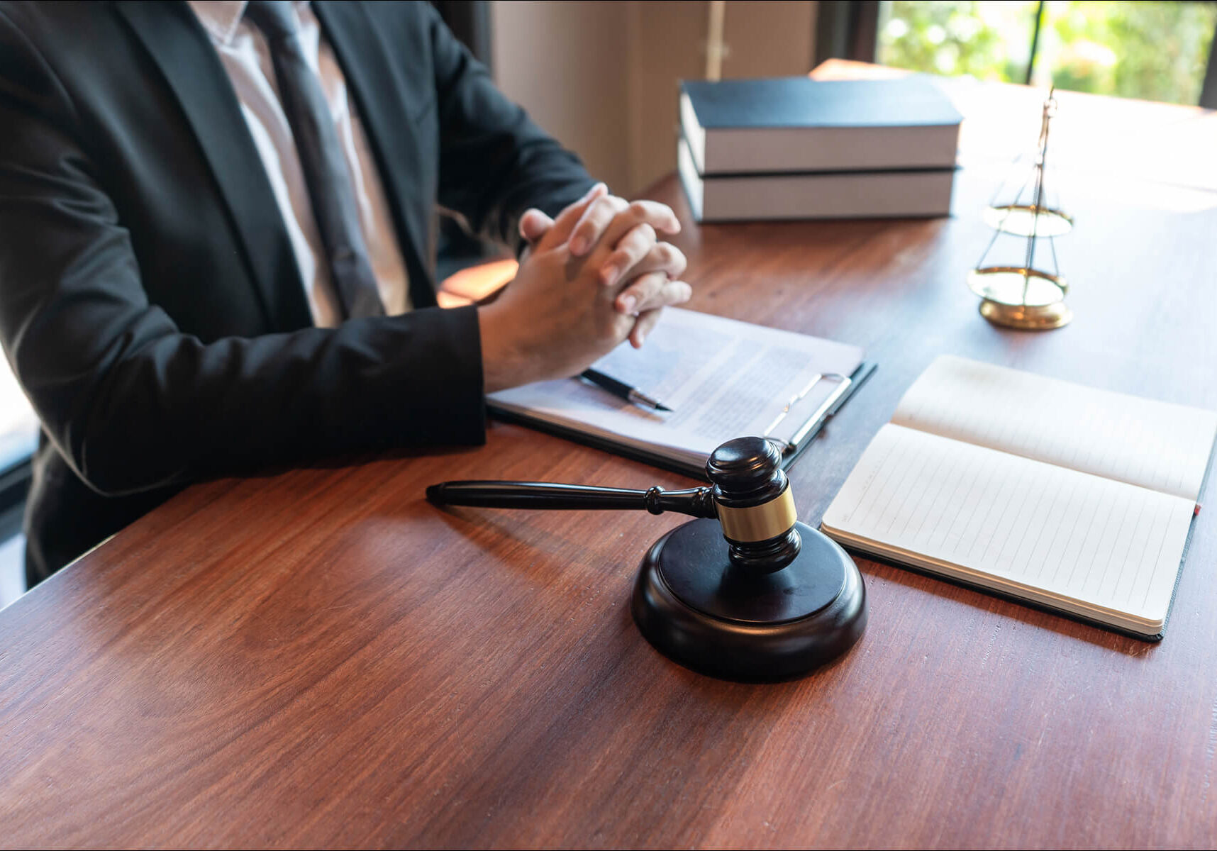Gavel on lawyer's desk with documents.